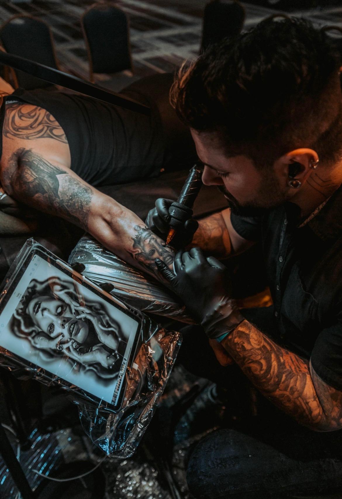 Realism tattoo by Jesse Vickers — overhead view of Medusa piece in Grand Blanc Michigan studio