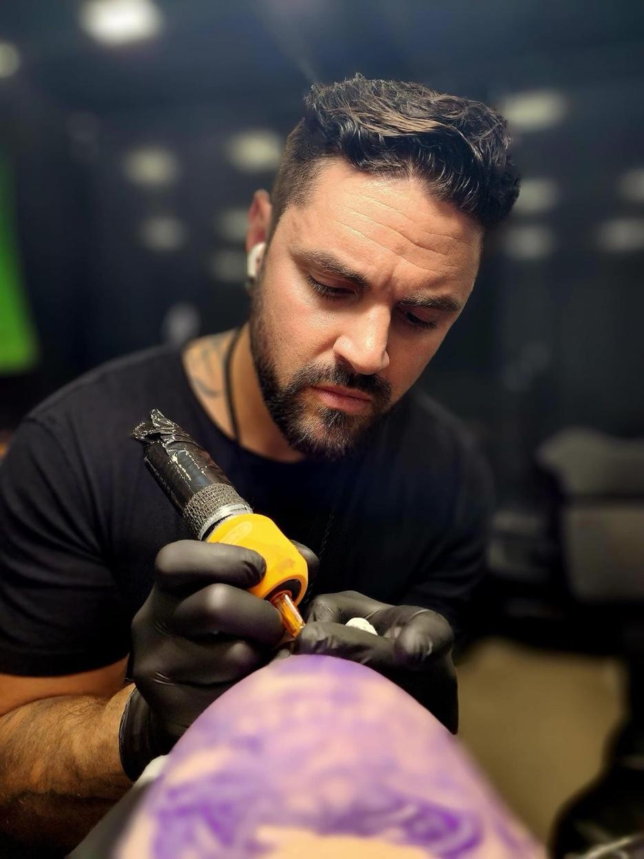 Custom tattoo design — Jesse Vickers applying stencil in private studio Grand Blanc MI